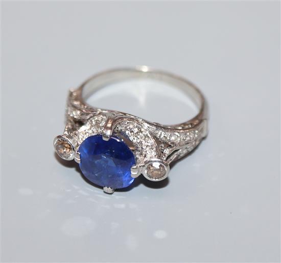 A white metal synthetic? sapphire and diamond set dress ring, size K.